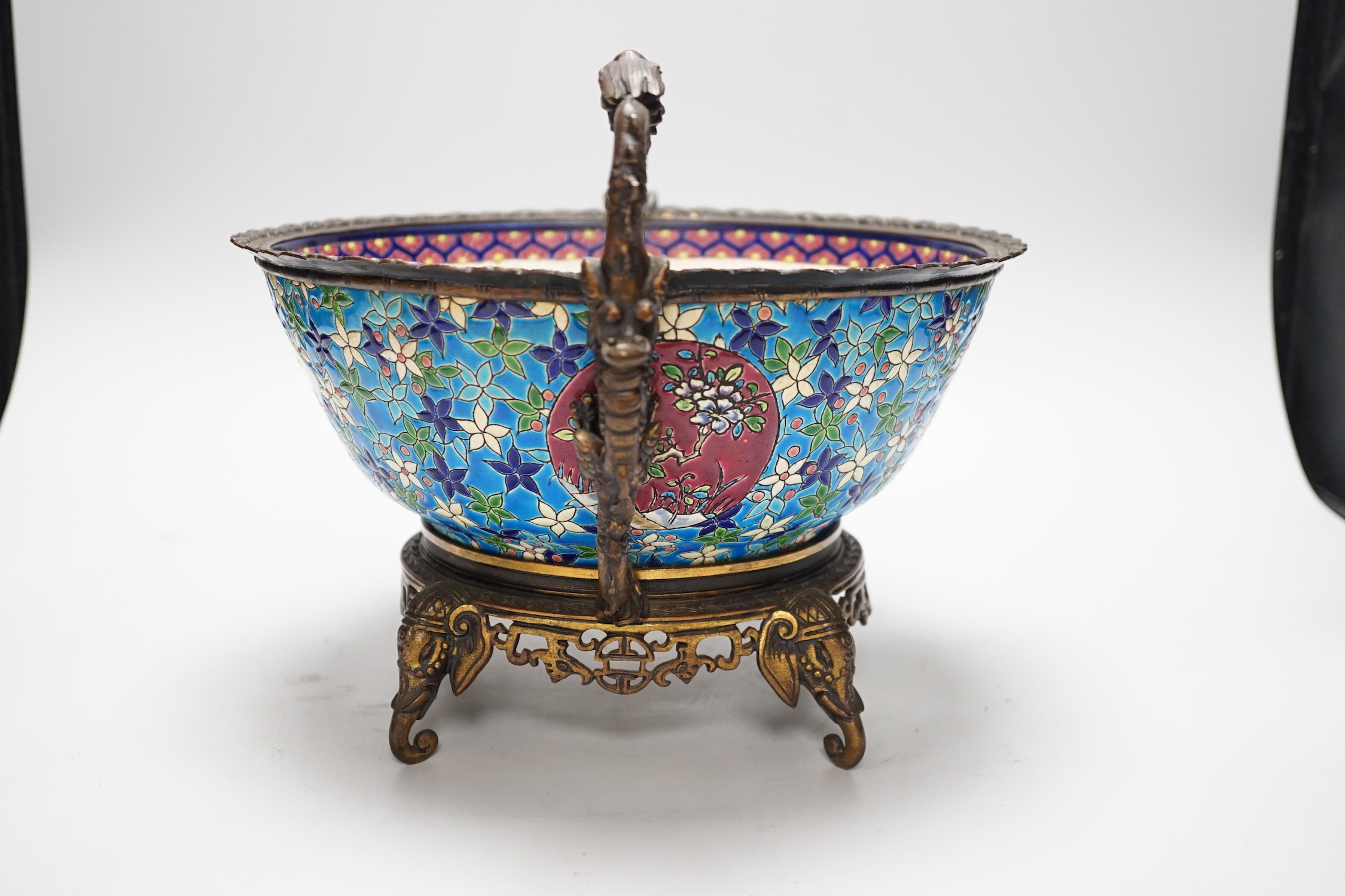 A 19th century French Longwy style ormolu mounted faience bowl on ornate dragon design stand, 23cm high